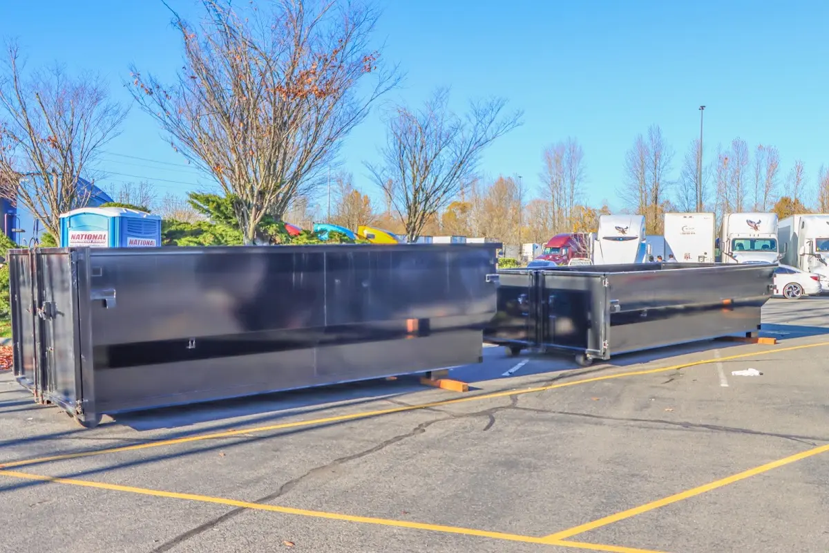 Professional dumpster rental service with roll-off container on residential driveway in Xenia